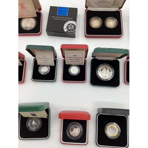 199 - A collection of silver and white metal commemorative  coins. To include silver proof examples.