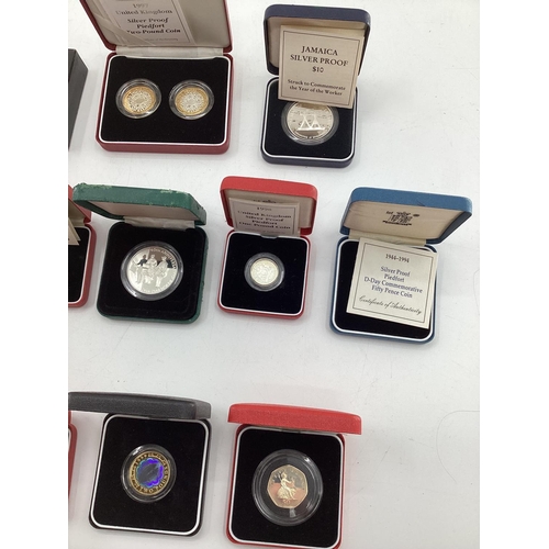 199 - A collection of silver and white metal commemorative  coins. To include silver proof examples.