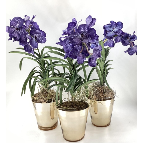 217 - Three  impressive faux flowers, of purple orchid arrangements in glass containers, and mirrored plan... 