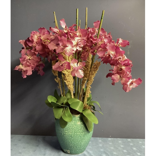 218 - A large impressive faux flower arrangement,  purple/Pink orchids, with bamboo sticks and foliage, in... 