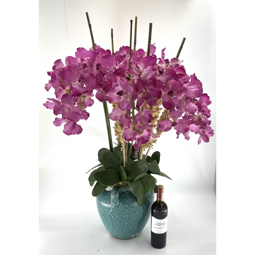 218 - A large impressive faux flower arrangement,  purple/Pink orchids, with bamboo sticks and foliage, in... 