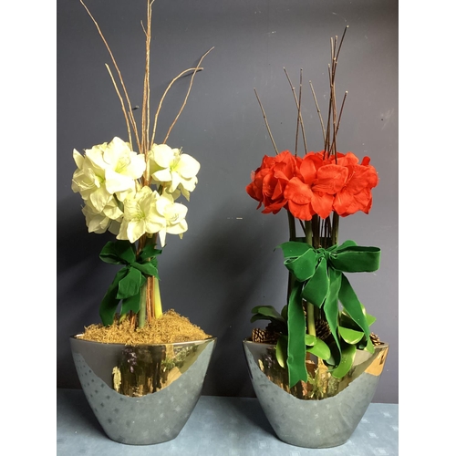 219 - Two faux flower arrangements, a white and red amaryllis, in contemporary mirrored oval planters, set... 