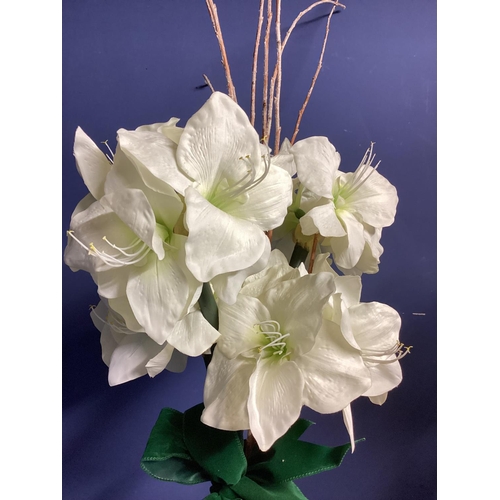 219 - Two faux flower arrangements, a white and red amaryllis, in contemporary mirrored oval planters, set... 