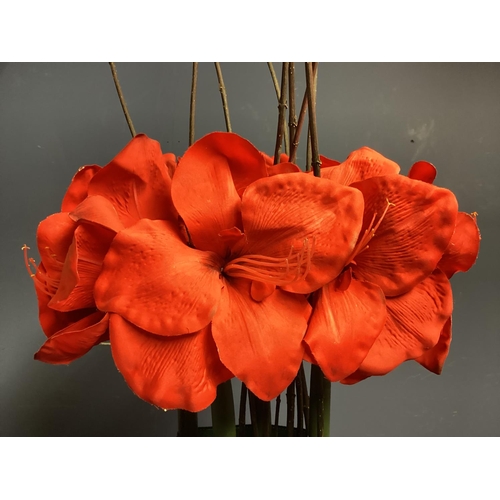 219 - Two faux flower arrangements, a white and red amaryllis, in contemporary mirrored oval planters, set... 