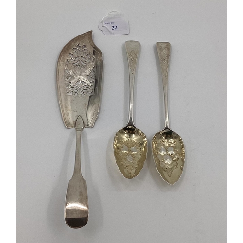 22 - A sterling silver fish slice and two Georgian desert spoons with later applied fruit and berry desig... 