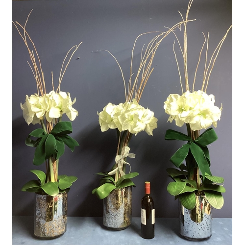 220 - Three faux flower arrangements,  white amaryllis, in contemporary  circular mirrored planters, set w... 