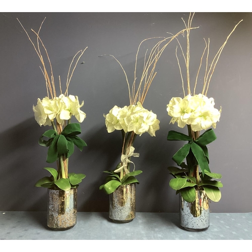 220 - Three faux flower arrangements,  white amaryllis, in contemporary  circular mirrored planters, set w... 