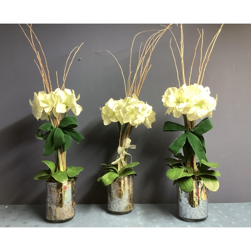 220 - Three faux flower arrangements,  white amaryllis, in contemporary  circular mirrored planters, set w... 