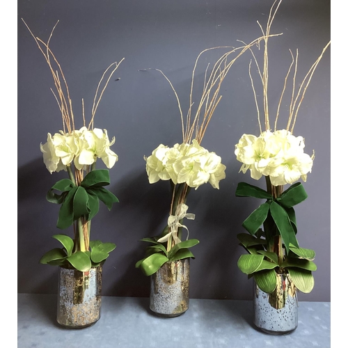 220 - Three faux flower arrangements,  white amaryllis, in contemporary  circular mirrored planters, set w... 