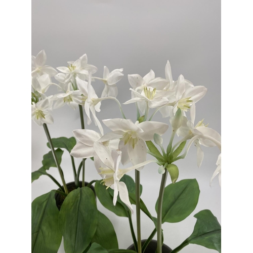 224 - Pair of decorative faux flowers, tall white arrangements in planter, with tall green foliage