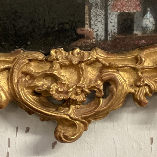 228 - A George III giltwood pier mirror last quarter of C18th, pierced scrolling top, to a shaped rectangu... 