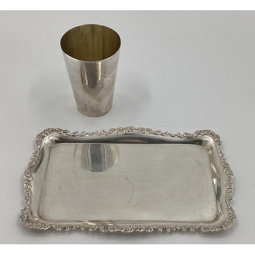 23 - A Victorian sterling silver beaker together with a small oblong silver card tray with cast scrolling... 