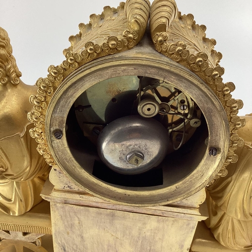 234 - Gilded French mantle clock, flanked by figures of Grecian women sat on Regency style cross stretcher... 