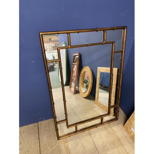 247 - Four modern wall mirrors, to include a large bamboo style rectangular wall mirror, a circular wall m... 