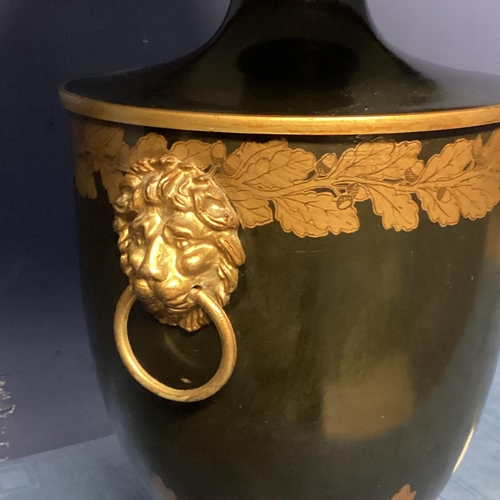 253 - Pair of black and gold lamps, on stepped base, with lion mask handles,  in the classical Grand Tour ... 