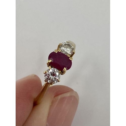 28 - An 18ct gold ruby and diamond ring single oval free cut ruby with brilliant cut diamond accents , 2.... 