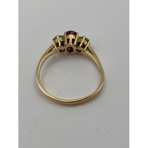 28 - An 18ct gold ruby and diamond ring single oval free cut ruby with brilliant cut diamond accents , 2.... 