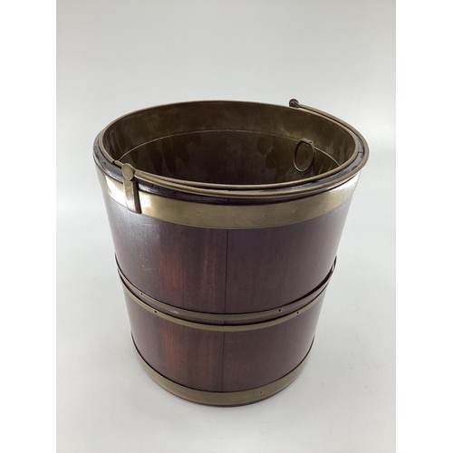 284 - A good mahogany and brass bound bucket, wit brass liner and carrying handle, 32cm H