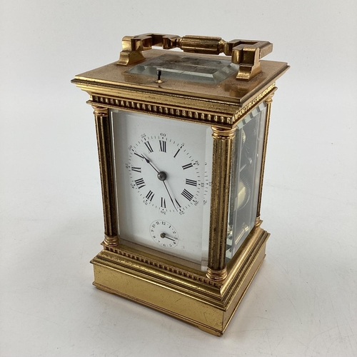 287 - A gilt brass carriage clock, with five glass panels, striking on a gong.