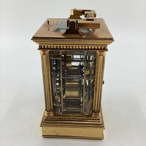 287 - A gilt brass carriage clock, with five glass panels, striking on a gong.