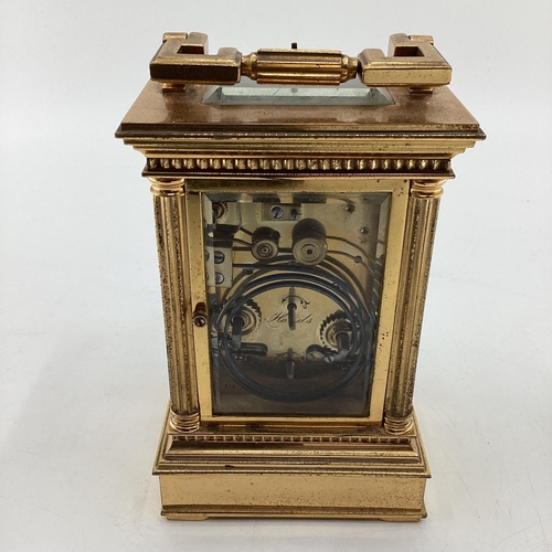 287 - A gilt brass carriage clock, with five glass panels, striking on a gong.