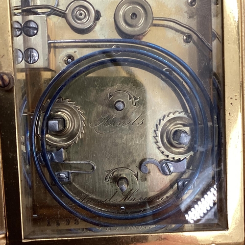 287 - A gilt brass carriage clock, with five glass panels, striking on a gong.