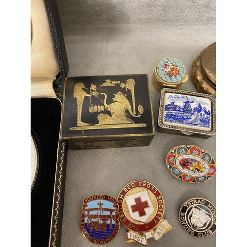 311 - A large collection of C20th collectable and school badges in a brass bound casket with two compacts