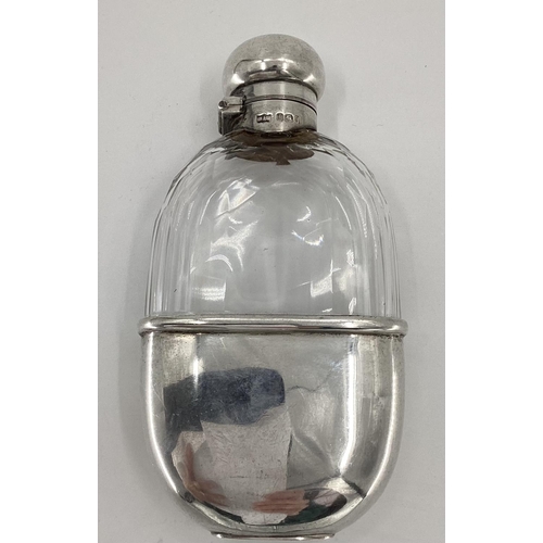 35 - A sterling silver and cut glass hip flask by Mappin & Webb Sheffield 1899; A pair of sterling silver... 