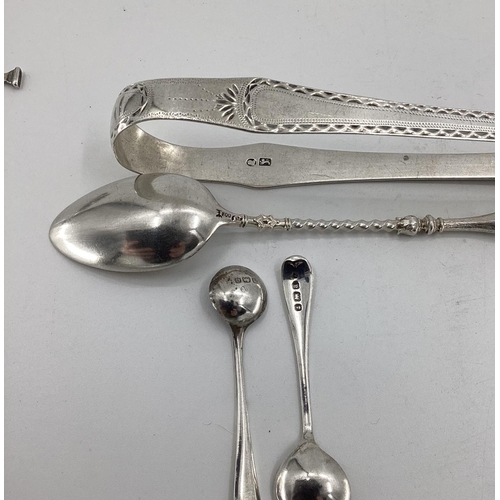 41 - A collection of sterling silver and white metal items to include sugar tongs, pickle fork etc, 170; ... 