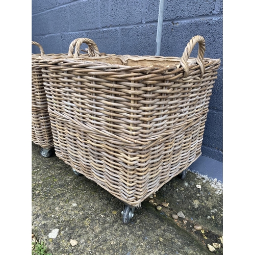 469 - Pair of log baskets on wheels. 
Dimensions are 60 cm x 60 cm x 70 cm height including wheels and han... 