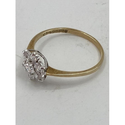 5 - A 9ct gold diamond flower ring set with seven brilliant cut diamonds, 1.1g, size M