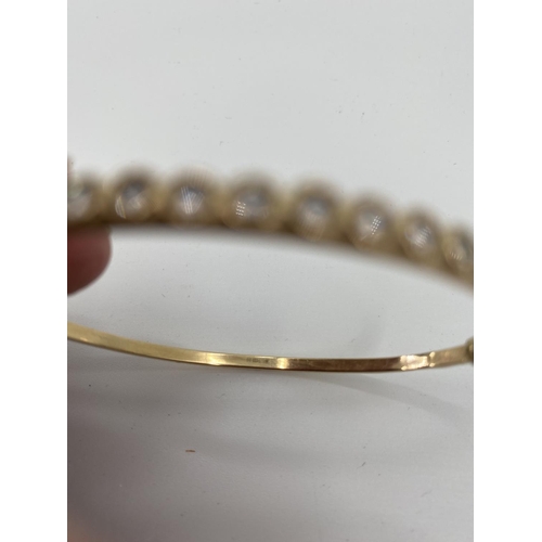 54 - Two 9ct gold bangle bracelets, one set with 12 single cut diamonds, 10g