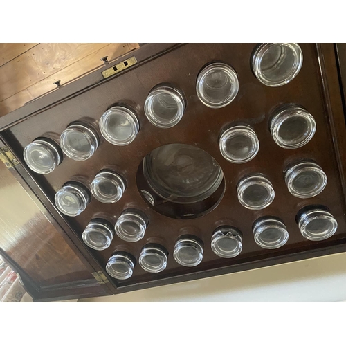 571 - A Georgian figured mahogany fold over top table, revealing 12 fitted glasses, surrounding a central ... 