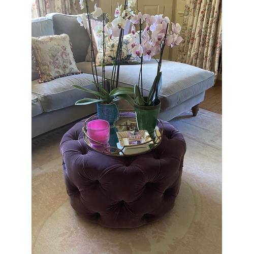 581 - Two Circular buttoned stools, upholstered in a green velvet fabric, and one in a purple  fabric