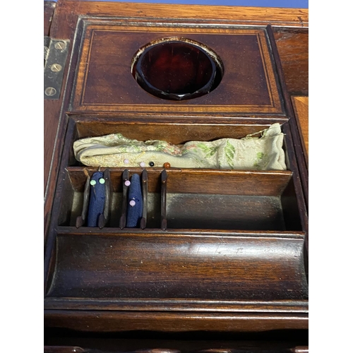 619 - A Regency inlaid and cross banded figured mahogany fold over washstand, with fitted interior, on tap... 