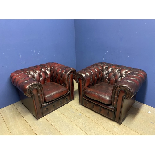 641 - Pair of red leather buttoned back large arm chairs, some wear