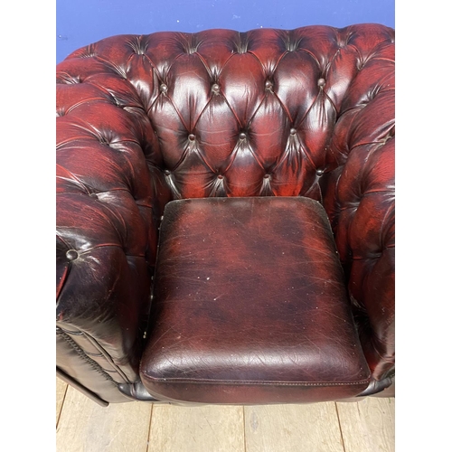 641 - Pair of red leather buttoned back large arm chairs, some wear