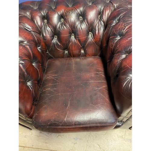 641 - Pair of red leather buttoned back large arm chairs, some wear