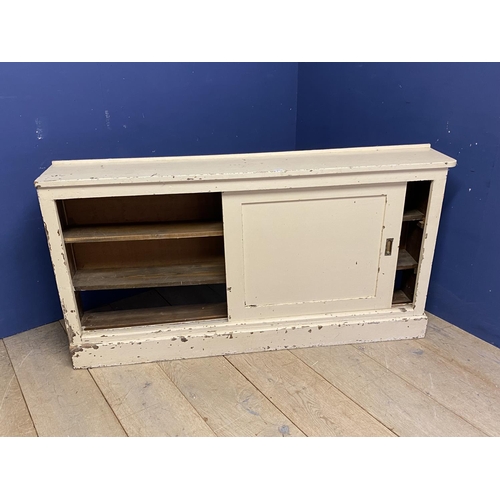 645 - Vintage style cream painted low side cupboard, the sliding doors opening to reveal shelves. Dimensio... 