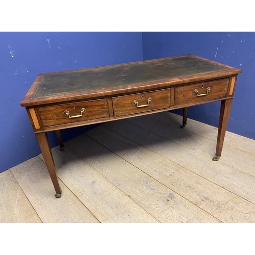 660 - A good mahogany writing table, with 3 drawers, below a tooled green leather skiver, on brass castors... 