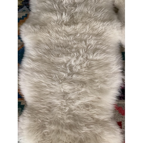 693 - Two 100% sheepskin rugs, 170 x 60cm