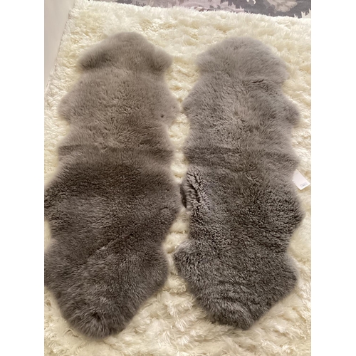 694 - Two 100% sheepskin silver grey rugs, 160 x 60cm