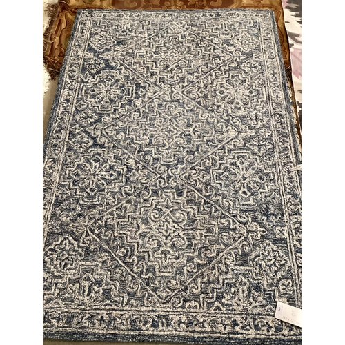 696 - FIVE rugs: Blue/cream 100% wool Indian pattern rug, 123 x 183; Tapestry style brown/red tones rug, l... 