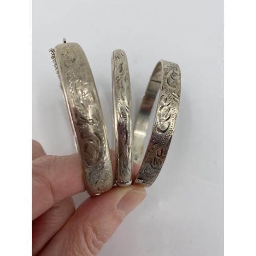 7 - Four sterling silver bangle bracelets all with chased decoration, 65g, and A collection of sterling ... 