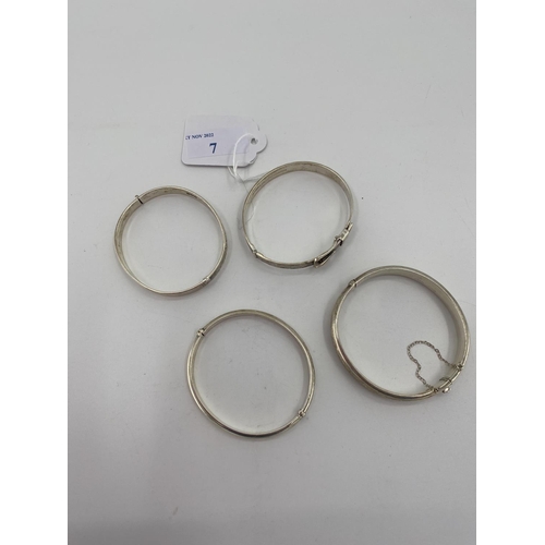 7 - Four sterling silver bangle bracelets all with chased decoration, 65g, and A collection of sterling ... 