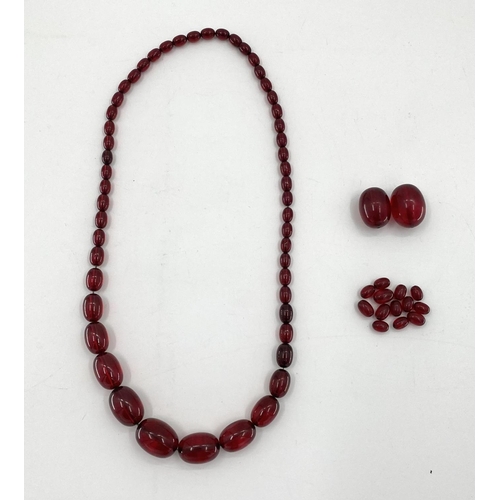 82 - A string of cherry amber graduated beads with additional beads, 106g, 70cm