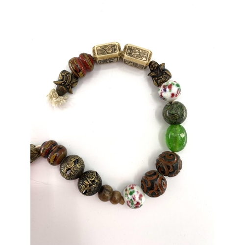 84 - A strand of antique Chinese glass court beads with a bone and coral examples