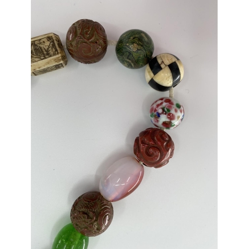 84 - A strand of antique Chinese glass court beads with a bone and coral examples