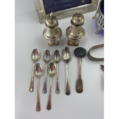 88 - A collection of sterling silver white metal items to include tea strainer, picture frame, ETC