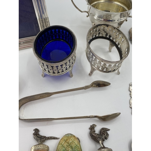 88 - A collection of sterling silver white metal items to include tea strainer, picture frame, ETC